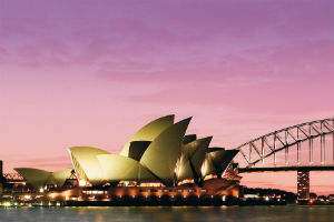 the Sydney Opera House and Harbour Bridge in a purple sunset